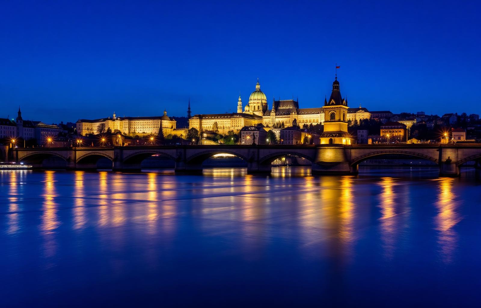 Prague Charles Bridge and castle skyline at blue hour over the Vltava